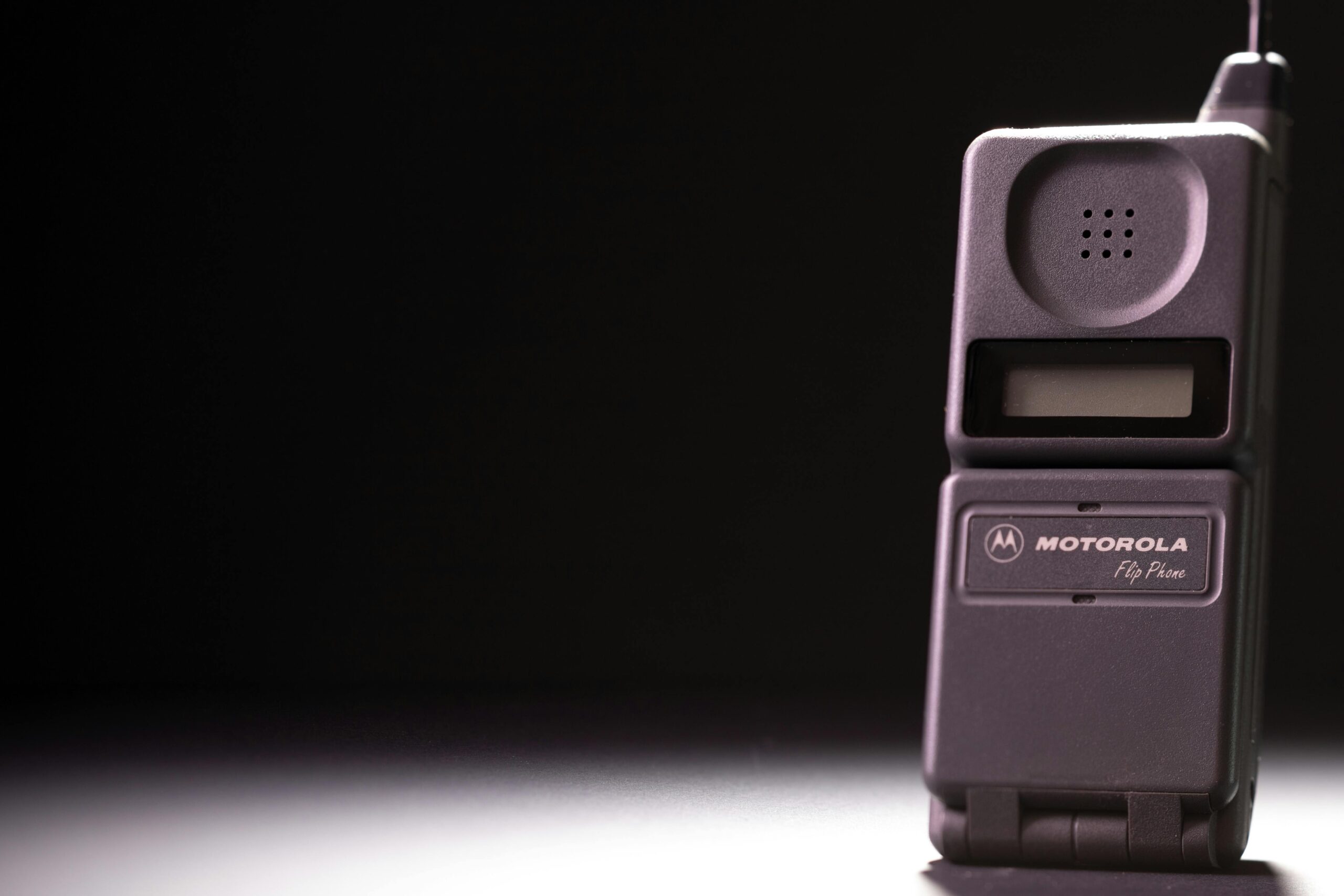 Classic Motorola flip phone on a dark background, highlighting its retro charm.
